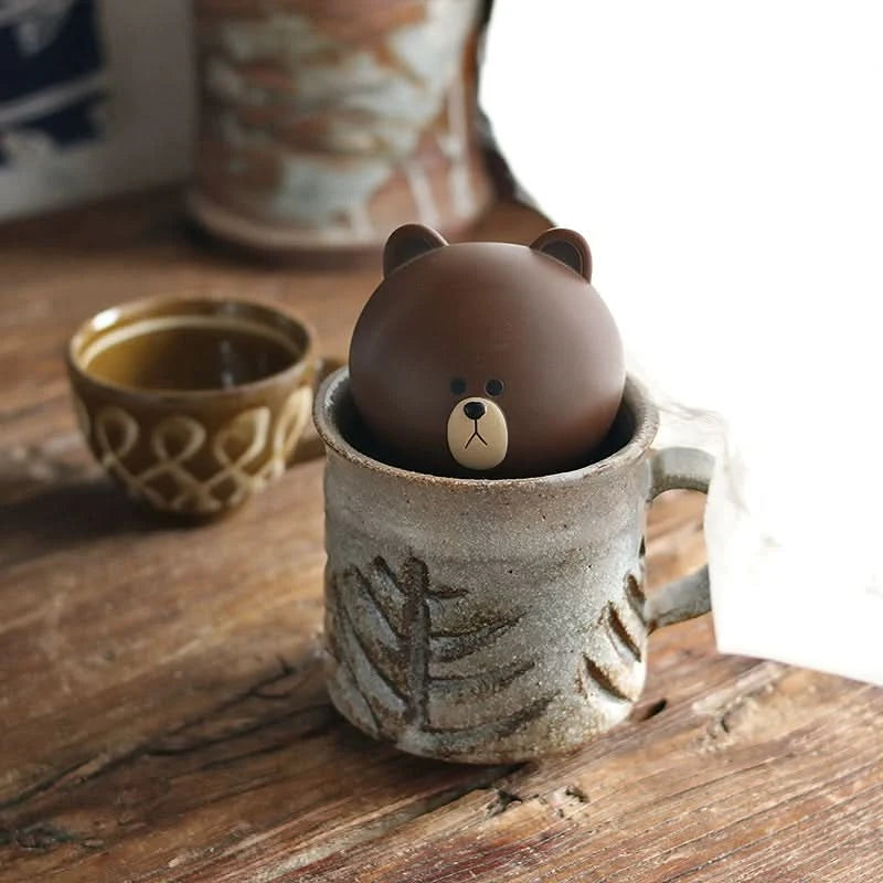 Rustic handmade ceramic coffee mug with bear lid, vintage style drinkware.